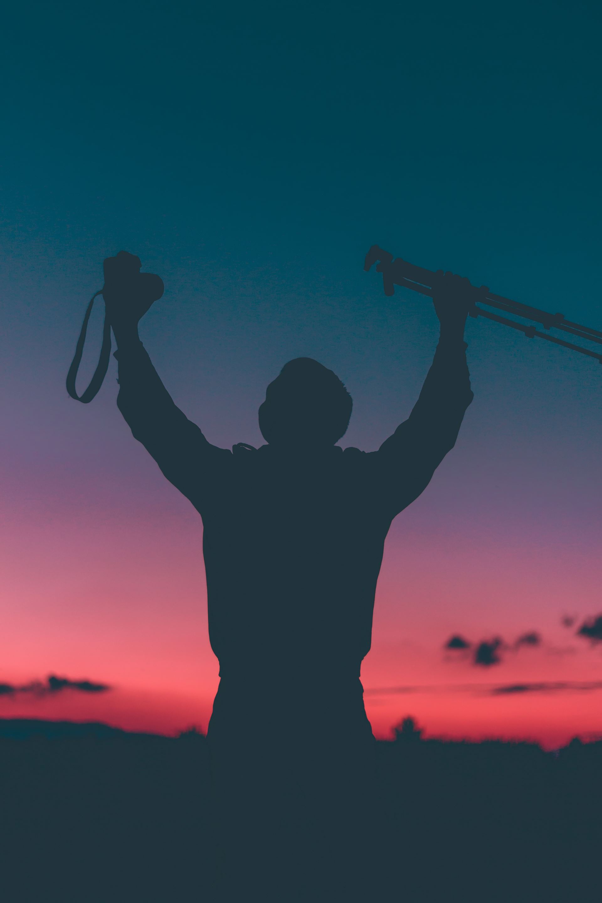 a man standing in front of a sunset